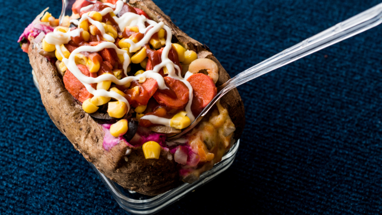 Kumpir is the Turkish version of a loaded baked potato. A large potato is baked until its skin is crispy, then mashed with butter and cheese. It’s then topped with a variety of ingredients such as corn, sausage, olives, and pickles, creating a customizable and indulgent street food treat.